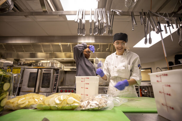 Two Female Culinary Arts Students Completing Food Prep for Emily's Cafe in Denver, CO