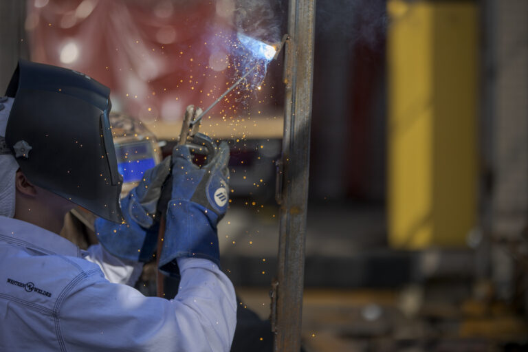 Welding Student Cutting and Sparks Flying in Denver, CO