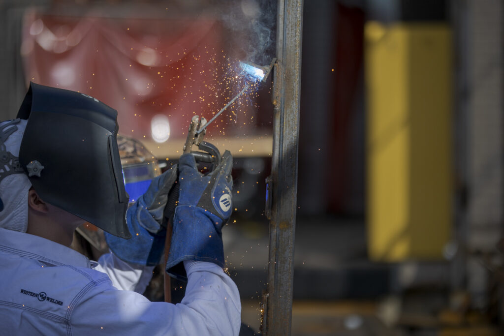 Welding Student Cutting and Sparks Flying in Denver, CO