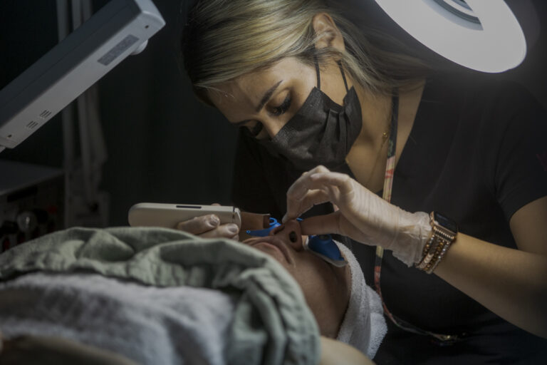 Female Esthetician Student Performs Facial Treatment on Client at Emily's Spa in Denver, CO