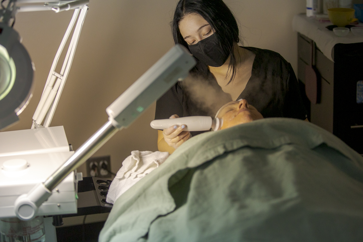 Esthetician Student Performs Facial Treatment on Client at Emily's Spa in Denver, CO