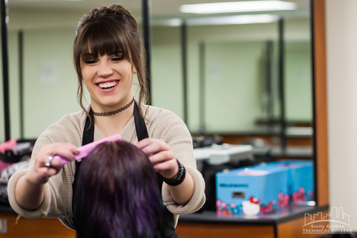 Cosmetology Smiling as She Combs Client's Hair in Denver, CO