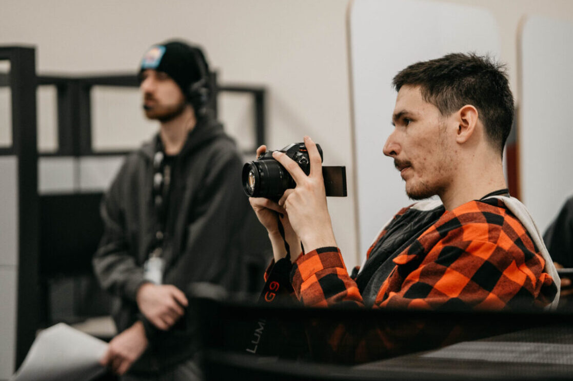 Two Male Multimedia and Video Production Students Listen and Photograph Video Podcast Recording in Denver, CO