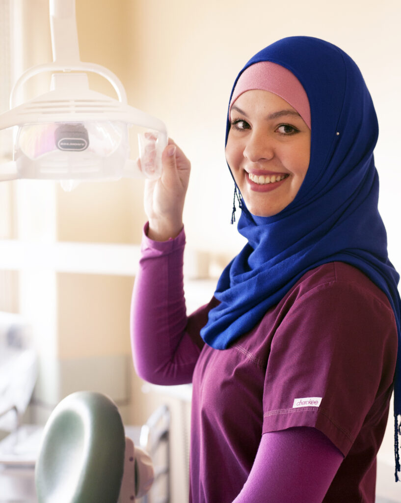 Dental Assisting student smiles directly at camera in Denver, CO