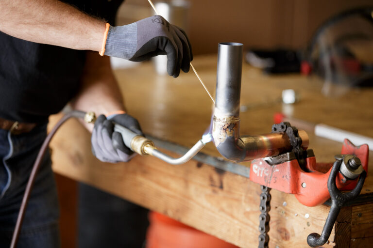 Plumbing Apprenticeship student practices soldering pipes