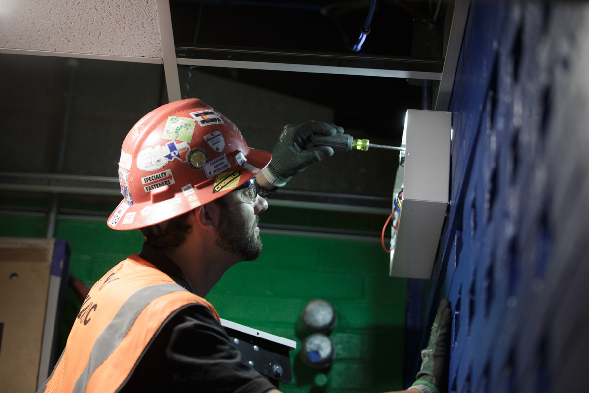 Electrician Apprenticeship student using screwdriver to fix wiring