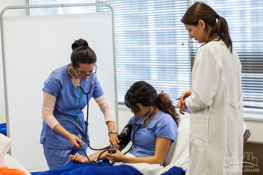 Nurse Assistant Student and Instructor Using Stethoscopes on Patient in Denver, CO