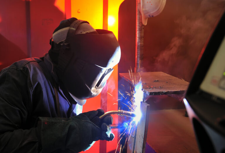 Welding Student Cutting and Sparks Flying in Denver, CO