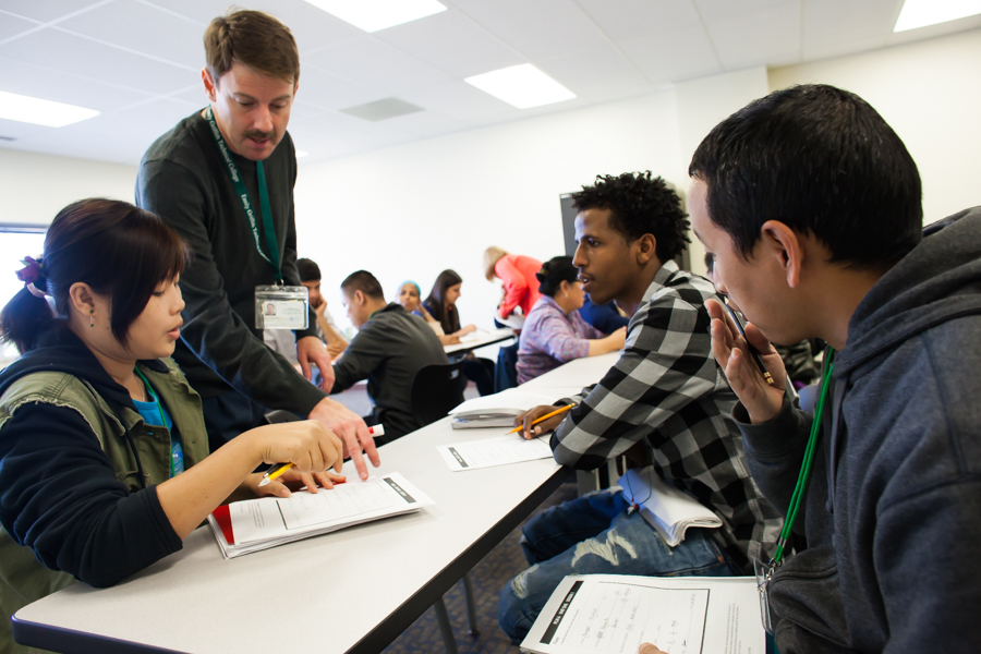 English Language Acquisition instructor working with a group of students
