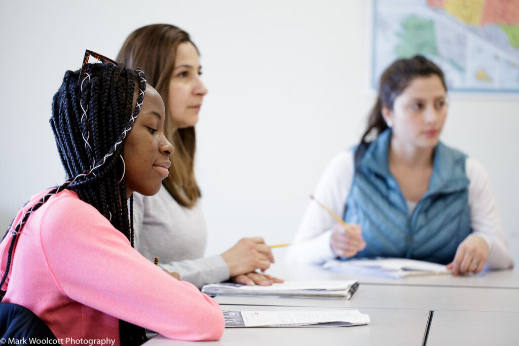 Students listening to instructor in class