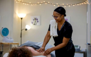 Massage Therapy student practicing on client