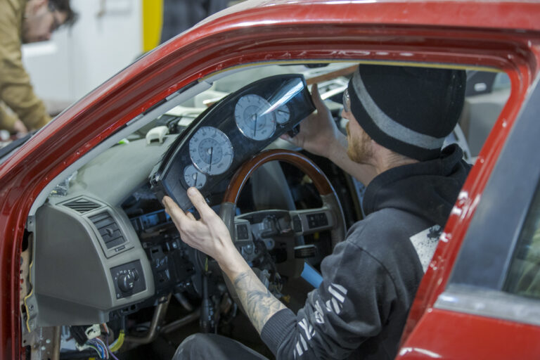 Automotive Service student working on dashboard of car