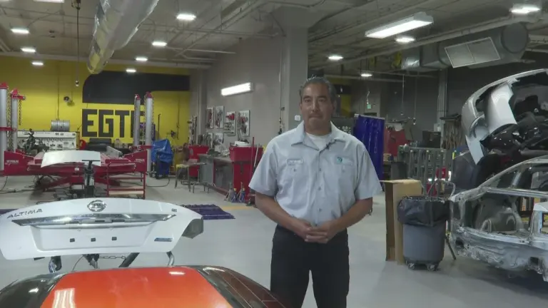 Jeremy Berrera, Automotive Service instructor, interviewing for CBS News