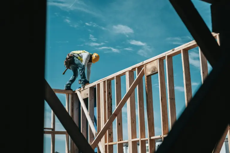 Construction worker building wood frame of structure