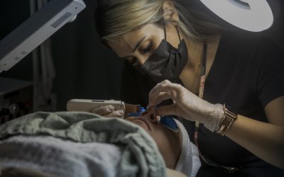 Female Esthetician Student Performs Facial Treatment on Client at Emily's Spa in Denver, CO