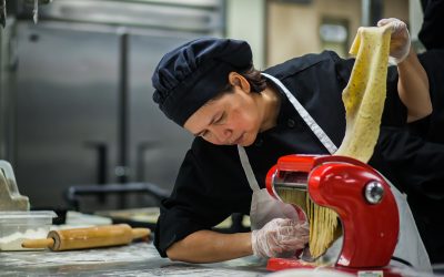 Female Culinary Arts Student Processes Homemade Pasta Dough for Emily's Cafe in Denver, CO
